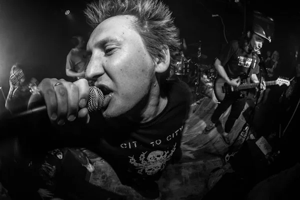 Singer shouting into a microphone, black and white