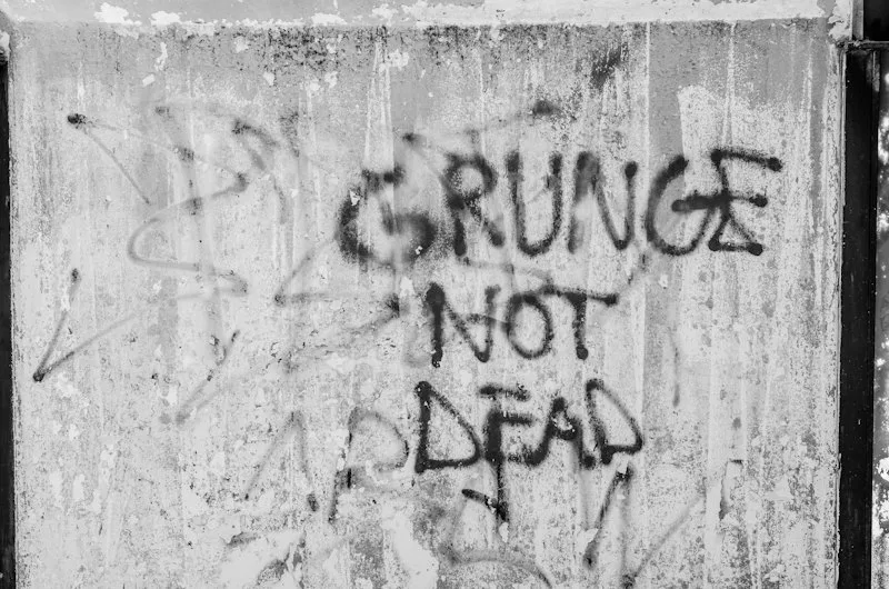 Concrete wall with Grunge Not Dead spray-painted on it