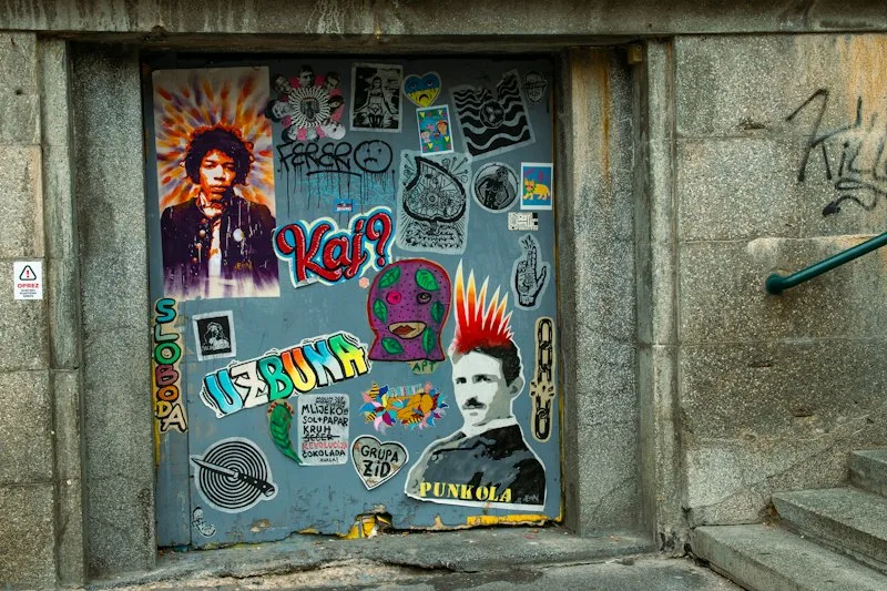Sticker-covered blue door in a stone wall